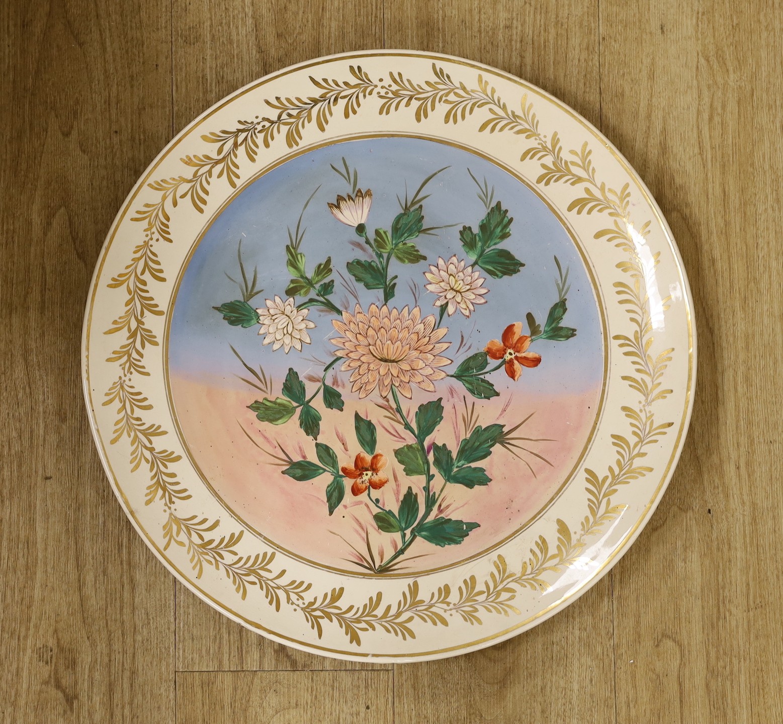 A large Doulton Burslem floral wall hanging charger, 49.5cm diameter